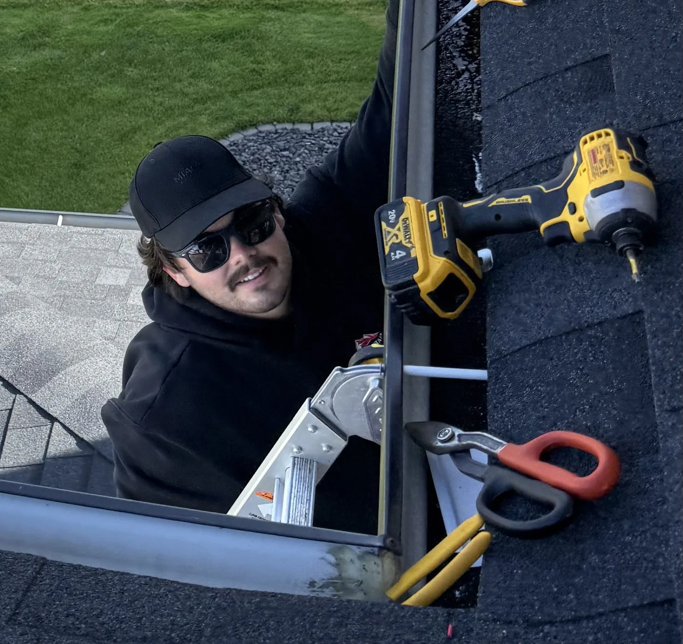 Installer planning lighting along a roofline