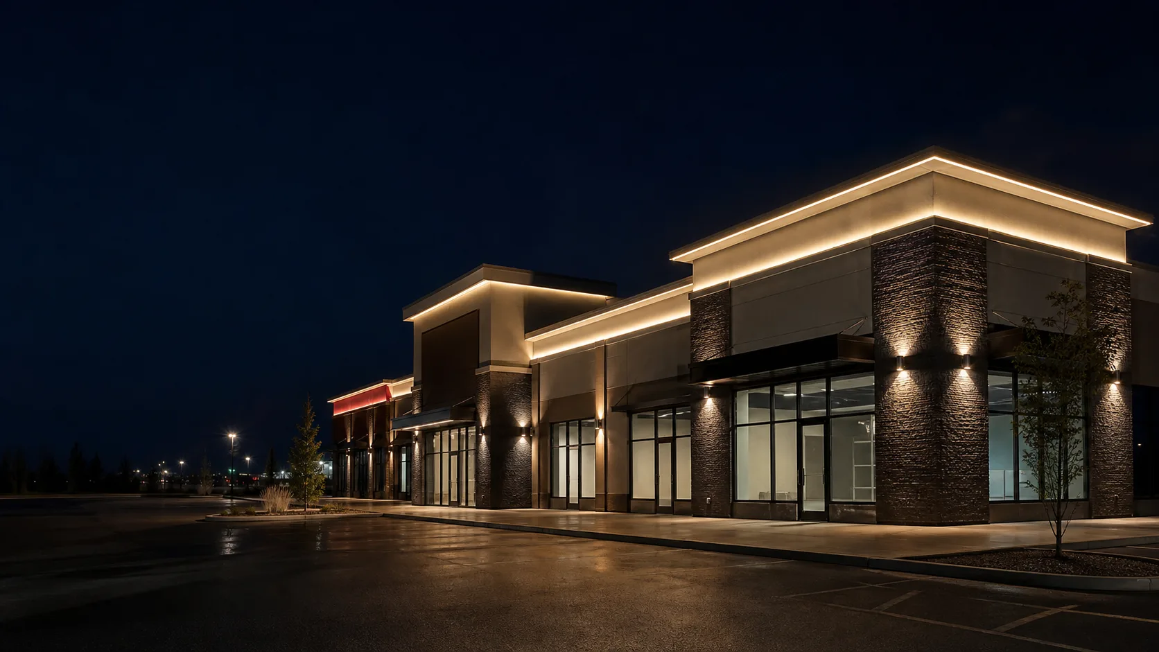 Warm-white architectural lighting outlining a modern commercial building at night
