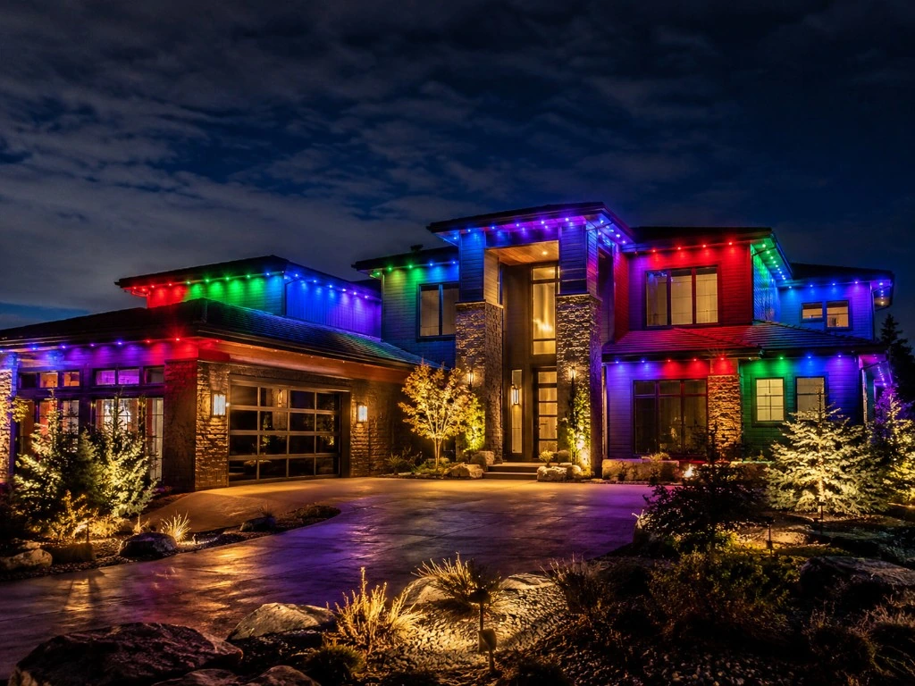 The same home lit with a tasteful red, green and warm white holiday pattern