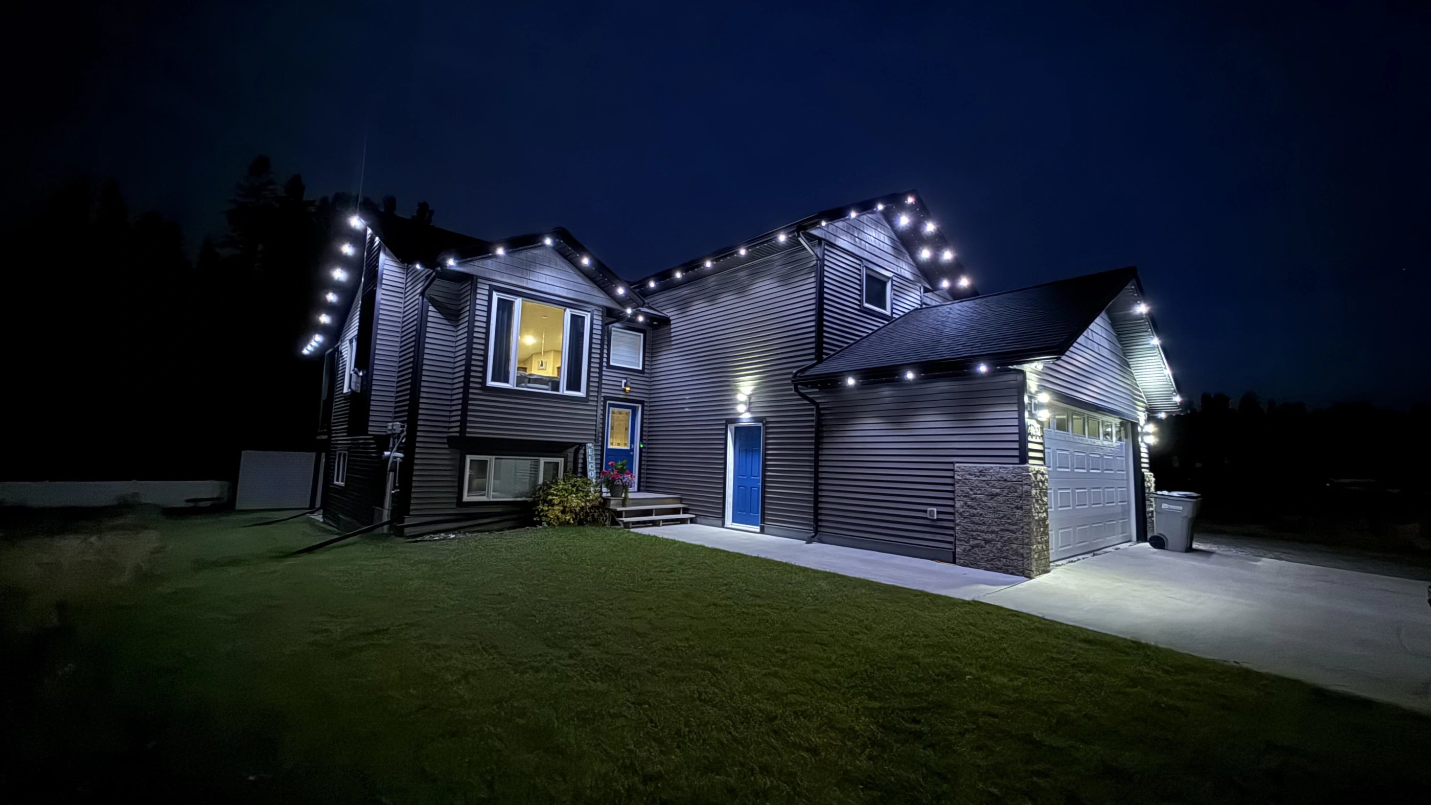 Brian’s home in Edson with permanent roofline lighting at night