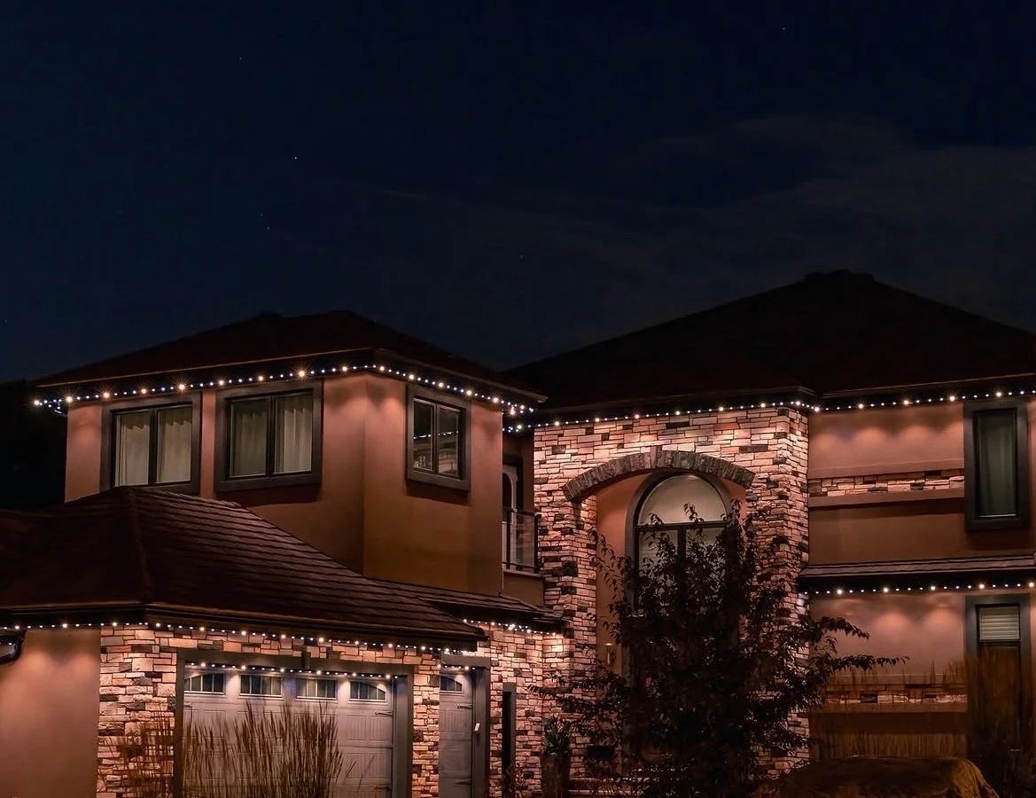 Estate home displaying warm-white Canstar permanent roofline lighting