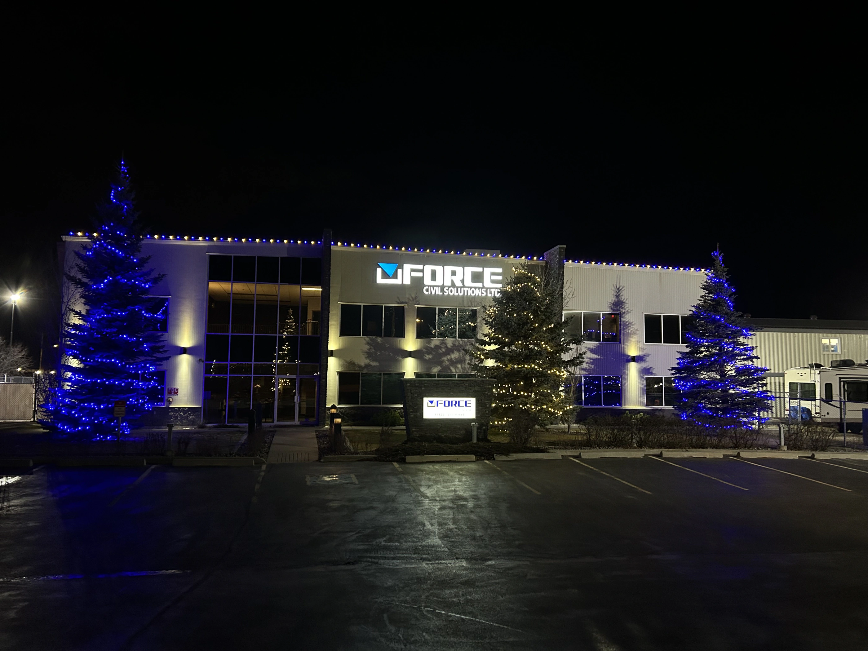 G Force Civil Solutions building and trees with Christmas lights at night